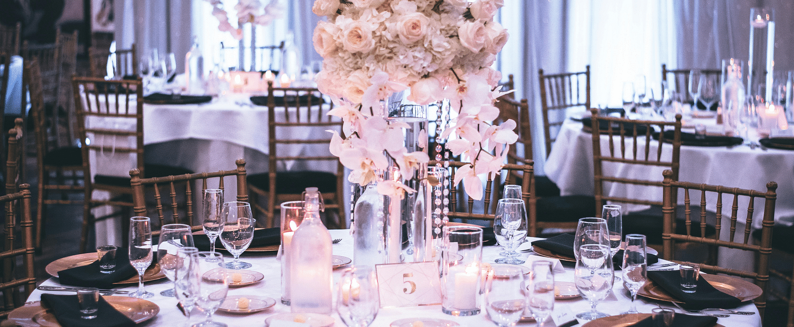 A beautifully decorated table for a special event, featuring a large floral arrangement.